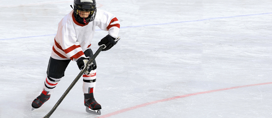 Six Year Old Hockey Player Racing with the Puck